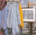 Hand-dyed threads ready to be woven, hanging alongside the original drawing, <i>Three Fates</i>…
