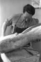 Henry Moore working on <i>Family</i> in the Top Studio, Perry Green, c.1943.<br><br>