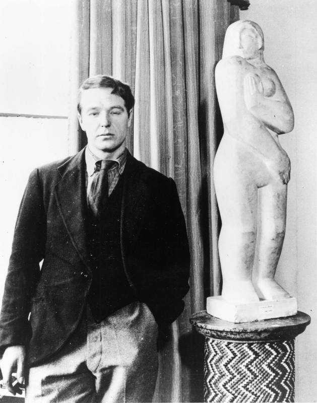 Henry Moore in 1928 with Standing Woman, 1926 (LH 33), catalogue number 10 in the Warren Galler…