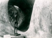 <i>Standing Figure No.1</i> 1952 (bronze) photographed against <i>Reclining Figure: External Fo…