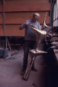 Noack Foundry, A Noack foundry assistant chasing, polishing and cleaning bronze castings