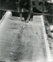 <i>Two Reclining Figures</i> being cut from the loom, West Dean Tapestry Studio, 1980.

Photo…