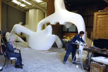Henry Moore with his assistant Malcolm Woodward in 1983, working on the polystyrene Large Recli…